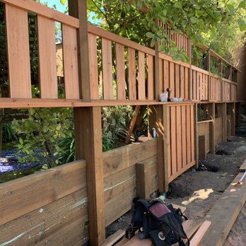 Hammerhead Construction - a wooden fence and bench - General Contractors Near Me