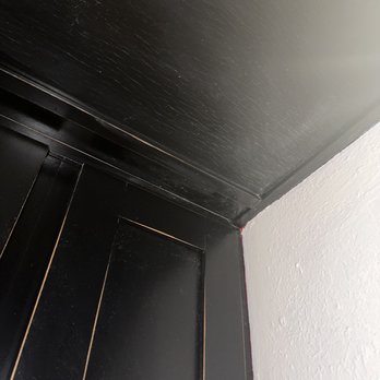 Transfer Hands - Underside of kitchen cabinets have overspray. Old wall color is still visible. - General Contractors Near Me