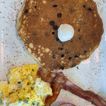 First Watch - Trifecta (chocolate chip pancake, scrambled eggs, and two pieces of bacon). - Breakfast & Brunch Near Me - Panama City Beach, Florida First Watch - Trifecta (chocolate chip pancake, scrambled eggs, and two pieces of bacon). - Breakfast & Brunch Near Me - Panama City Beach, Florida