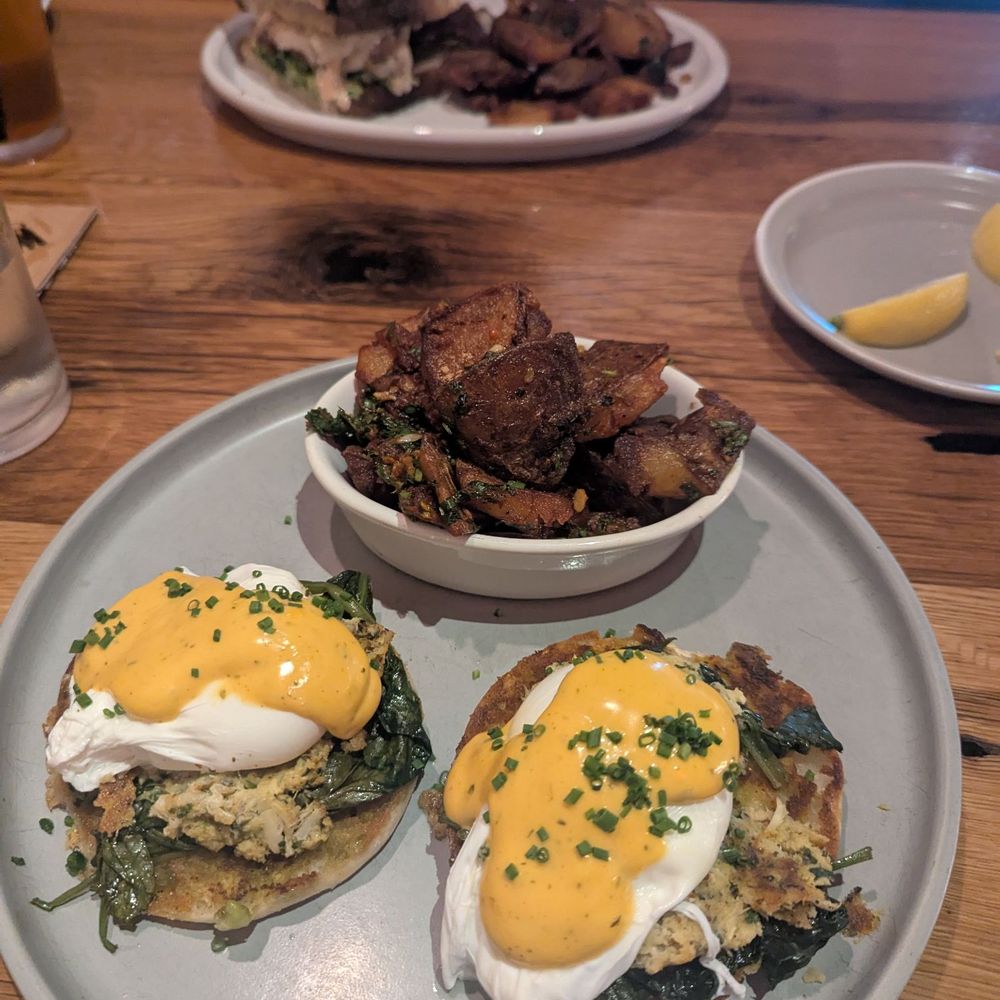 Crab Benedict and chicken melt, both with chili butter potatoes Crab Benedict and chicken melt, both with chili butter potatoes