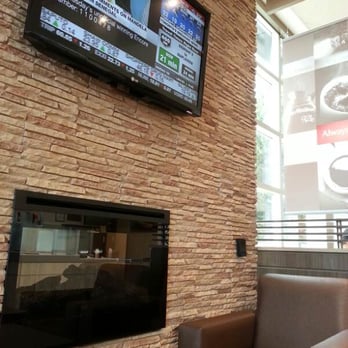 Tim Hortons - a television mounted on a brick wall - Donuts Near Me - Scarborough, Ontario Tim Hortons - a television mounted on a brick wall - Donuts Near Me - Scarborough, Ontario