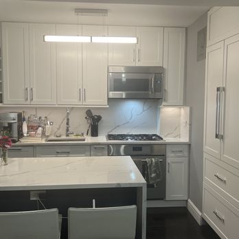 AIS Repairs & Renovations - After: Renovated kitchen with panel ready appliances. - General Contractors Near Me