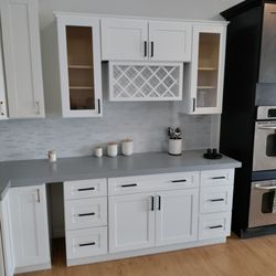 Pahrump Wholesale Cabinets - Installation and fabrication White Shaker cabinets ..Light Grey Quartz Countertops Looks good together.