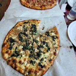 two pizzas on a table two pizzas on a table