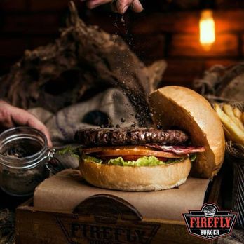 Firefly Burger - a hand sprinkling a burger - Burgers Near Me - Chicago, Illinois