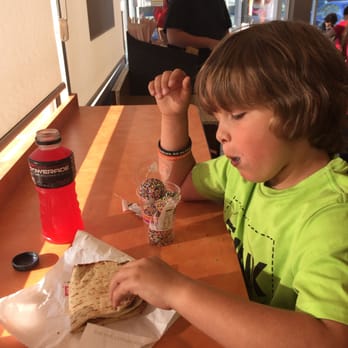 Dunkin' - a young boy eating a pita sandwich - Donuts Near Me - Dover, New Hampshire Dunkin' - a young boy eating a pita sandwich - Donuts Near Me - Dover, New Hampshire