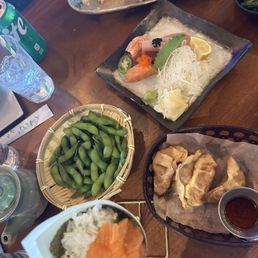 Edamame, gyozas, and sake sashimi, assorted sashimi appetizer. Edamame, gyozas, and sake sashimi, assorted sashimi appetizer.