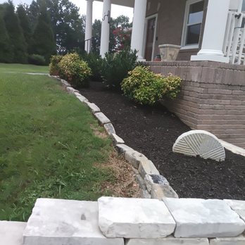 Nashville Yardscapes - Another front bed. The border stones are old cobblestones reclaimed from first Avenue in Nashville decades ago. - Landscaping Near Me