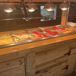 a buffet with hot dogs and other foods