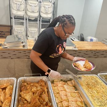 Momma Dee's - Owner of Momma Dee's Soul Food & Catering preparing a fresh buffet plate with baked chicken, lemon garlicsalmon, garlic butter mash potatoes - Caterers Near Me - Chicago, Illinois Momma Dee's - Owner of Momma Dee's Soul Food & Catering preparing a fresh buffet plate with baked chicken, lemon garlicsalmon, garlic butter mash potatoes - Caterers Near Me - Chicago, Illinois