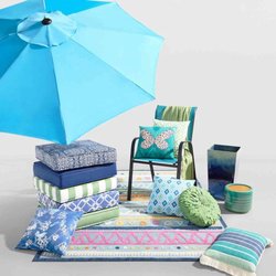 At Home - A set of modern outdoor patio chairs placed on a wooden deck, overlooking a lush garden, ideal for relaxing and enjoying the ...