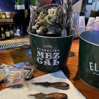 The Windjammer - A bucket of oysters during the weekend roast! $15 per bucket. Our personal oyster knives are in this photo! - Bars Near Me - Isle of Palms, South Carolina The Windjammer - A bucket of oysters during the weekend roast! $15 per bucket. Our personal oyster knives are in this photo! - Bars Near Me - Isle of Palms, South Carolina