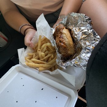 Da- Red Wagon -  a woman holding a sandwich and french fries - Barbeque Near Me - Flint, Michigan