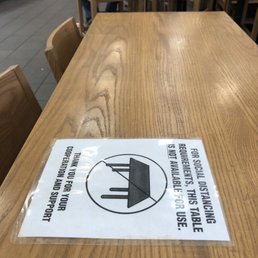 a table with a sign on it a table with a sign on it