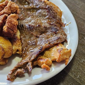 Rincon Catracho - The beef steak of the Bandeja Paisa with the chicken steak under it and the Colombian sausage above. - Honduran Near Me - Roanoke, Virginia Rincon Catracho - The beef steak of the Bandeja Paisa with the chicken steak under it and the Colombian sausage above. - Honduran Near Me - Roanoke, Virginia