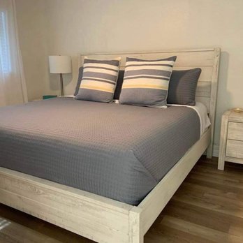 Dynamic homes - a bedroom with a bed and nightstand - Landscaping Near Me - Tillamook, Oregon Dynamic homes - a bedroom with a bed and nightstand - Landscaping Near Me - Tillamook, Oregon