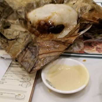 Tim Ho Wan - Sticky rice wrapped in lotus leaf. This had miscellaneous meats (sausage, I think beef??) inside with a sauce. - Dim Sum Near Me - Irvine, California Tim Ho Wan - Sticky rice wrapped in lotus leaf. This had miscellaneous meats (sausage, I think beef??) inside with a sauce. - Dim Sum Near Me - Irvine, California