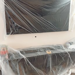 Plastic wrapped TV and our console before doing the job Plastic wrapped TV and our console before doing the job