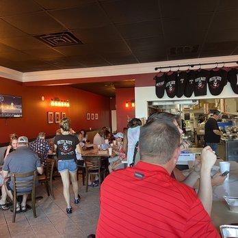 Outcast Seafood - people sitting at tables in a restaurant - Seafood Near Me - Miramar Beach, Florida Outcast Seafood - people sitting at tables in a restaurant - Seafood Near Me - Miramar Beach, Florida