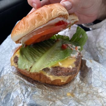 Wendy's - a hand holding a sandwich with lettuce, tomato, and cheese - Burgers Near Me - Charlotte, North Carolina Wendy's - a hand holding a sandwich with lettuce, tomato, and cheese - Burgers Near Me - Charlotte, North Carolina
