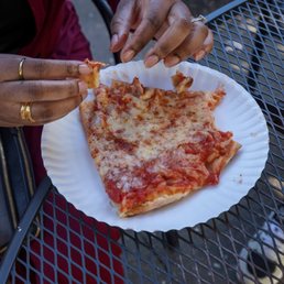 a slice of pizza on a paper plate a slice of pizza on a paper plate