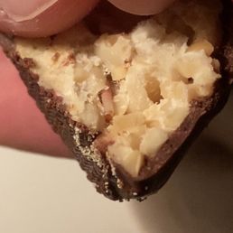 a hand holding a piece of food