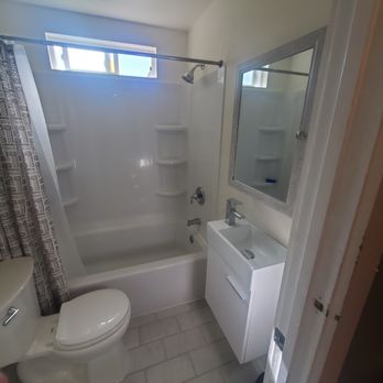 Quality One Property Services - a bathroom with a toilet, sink, and bathtub - Handyman Near Me - Seattle, Washington Quality One Property Services - a bathroom with a toilet, sink, and bathtub - Handyman Near Me - Seattle, Washington