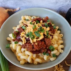 Our Chili Mac. Spiced beef and bean chili mixed with our bold cheddar sauce and topped with more shredded cheddar and green onions.