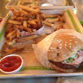 BurgerFi - VegeFi Burger, large fries, and a BurgerFi Cheeseburger in the distance. - Burgers Near Me - Aventura, Florida BurgerFi - VegeFi Burger, large fries, and a BurgerFi Cheeseburger in the distance. - Burgers Near Me - Aventura, Florida