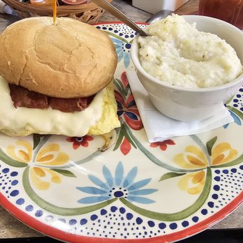 Marguerite's - Food - Egg and cheese sandwich , kaiser bun , bacon , and side of grits - Breakfast & Brunch Near Me - Dunedin, Florida