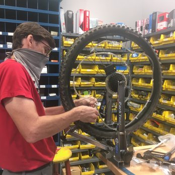 The Spokesman - Fixing the wheel - Bikes Near Me - Mandeville, Louisiana
