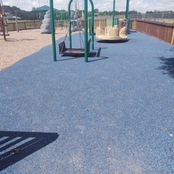 All Kids Park - This is the wheel chair accessible swing. The blue mats are ",bouncy" nice safety feature!