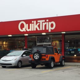 a car parked in front of a quikkrip store a car parked in front of a quikkrip store