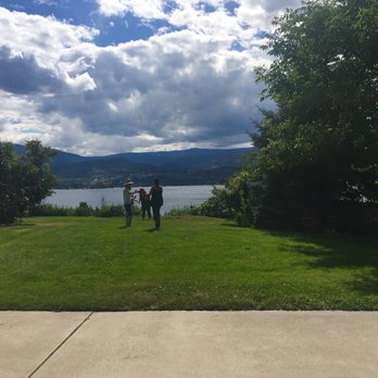 Kettle Valley Winery - a man and a woman standing on a lawn overlooking a lake - Wineries Near Me - Naramata, British Columbia Kettle Valley Winery - a man and a woman standing on a lawn overlooking a lake - Wineries Near Me - Naramata, British Columbia