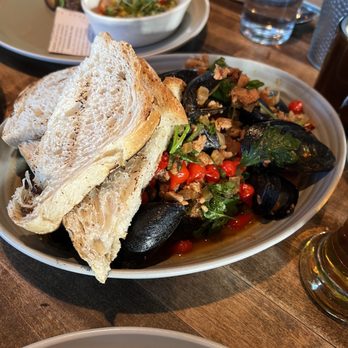 Whiskey Cake - Mussels in the foreground. Half of the WTF burger in the back. - New American Near Me - Plano, Texas Whiskey Cake - Mussels in the foreground. Half of the WTF burger in the back. - New American Near Me - Plano, Texas