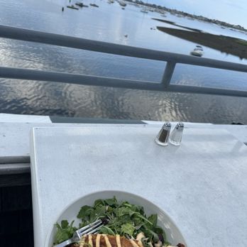 Mill Wharf Restaurant & Pub - a plate of food on a table overlooking the water - Seafood Near Me - Scituate, Massachusetts Mill Wharf Restaurant & Pub - a plate of food on a table overlooking the water - Seafood Near Me - Scituate, Massachusetts
