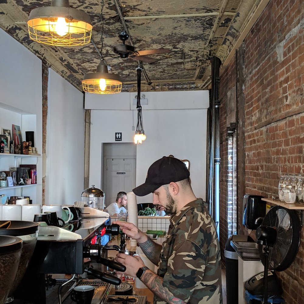 Safehouse Coffee - a man working in a coffee shop - Coffee & Tea Near Me - Toronto, Ontario Safehouse Coffee - a man working in a coffee shop - Coffee & Tea Near Me - Toronto, Ontario