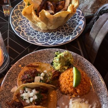 Caló Kitchen + Tequila - Pineapple carnitas tacos in front and chicken tostada in back - Cocktail Bars Near Me - Costa Mesa, California Caló Kitchen + Tequila - Pineapple carnitas tacos in front and chicken tostada in back - Cocktail Bars Near Me - Costa Mesa, California