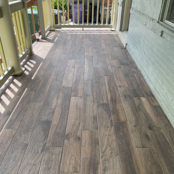Otto Custom Builders - Patio renovation: install new porcelain wood plank tile and build new railing on stairs - Handyman Near Me