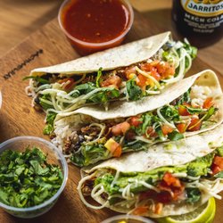 3 soft tacos with chicken and fresh toppings and red salsa and mexican soda