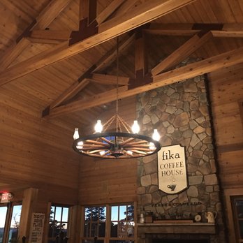 Whimsical Wagon Wheel Chandelier Stone Fire Place Vaulted