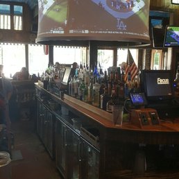 a bar with people sitting at the bar a bar with people sitting at the bar