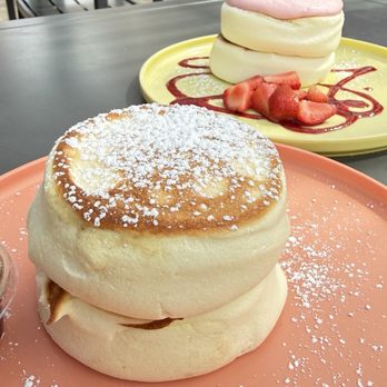 Burnt Crumbs - Original Soufflé Pancakes $14. Served with fresh whipped butter & syrup.   Strawberry Cream & Fresh Strawberries $16. - New American Near Me - Irvine, California