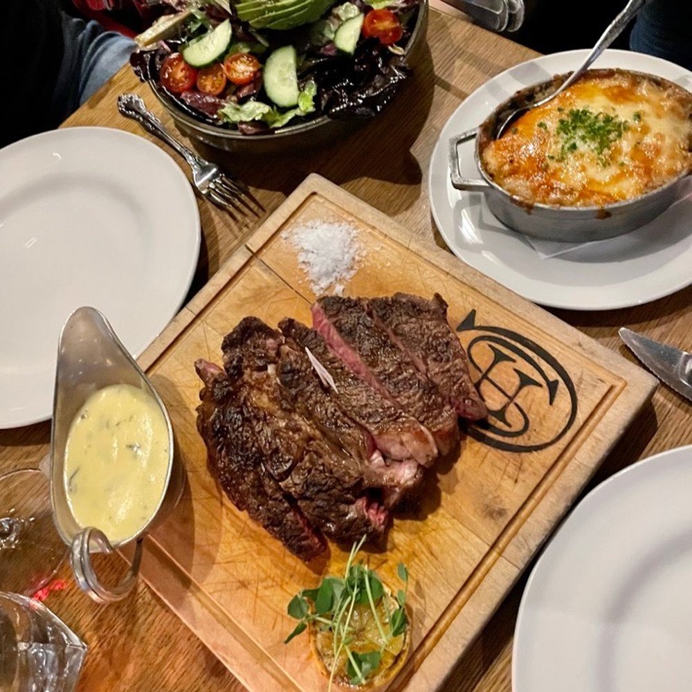 Chuck's Steakhouse - Ribeye, potato gratin, salad - Steakhouses Near Me - Banff, Alberta