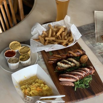 Radegast Hall and Biergarten - Sausage platter; spicy pork, jalapeño chicken, kielbasa (and fries .. also delish) - Pubs Near Me - Brooklyn, New York