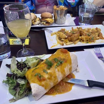 Hamburger Mary's - Denver - Vegetarian breakfast burrito with poutine tots and breakfast sliders in background - American Near Me - Denver, Colorado Hamburger Mary's - Denver - Vegetarian breakfast burrito with poutine tots and breakfast sliders in background - American Near Me - Denver, Colorado