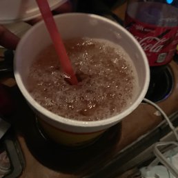 a person pouring a drink into a cup a person pouring a drink into a cup