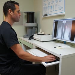 Eric Wee, DPM - Dr. Wee reviewing patient's foot X-rays