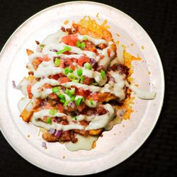 Z Bar & Grill - Garbage Fries- Fries tossed in Siracha seasoning & Garlic Salt then loaded with Bacon, Red Onions, Jalepenos, Tomatoes, Ranch & Queso.