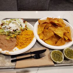 La Olla Mexican Cruisine - Chips, green salsa and enchilada with rice and beans.